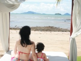 Traveling mom with girl at beach