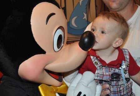 Baby Kissing Mickey Mouse At Disney World