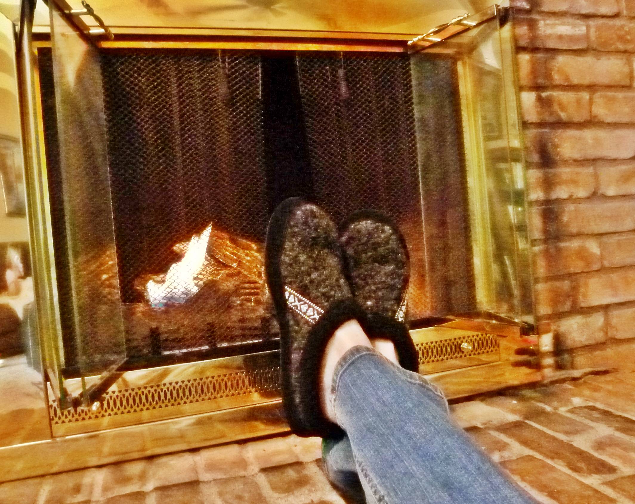 Acorn Snowline Mule Slippers by the fireplace