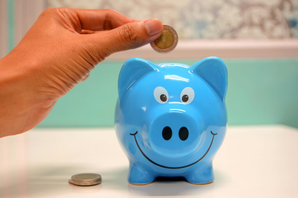 person saving money in piggy bank